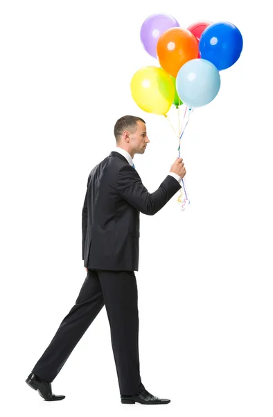 Profil des Gehens mit Luftballons Geschäftsmann — Stockfoto