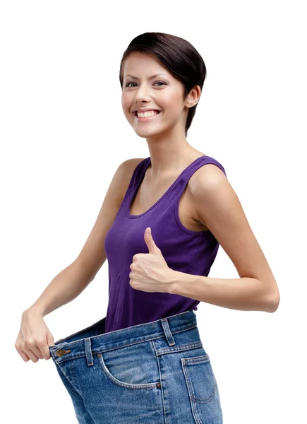 Slim woman wearing big jeans — Stock Photo, Image