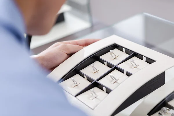 Male looking at the collection of rings — Stock Photo, Image