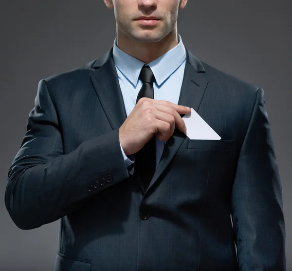 Man takes out white card from the pocket — Stock Photo, Image