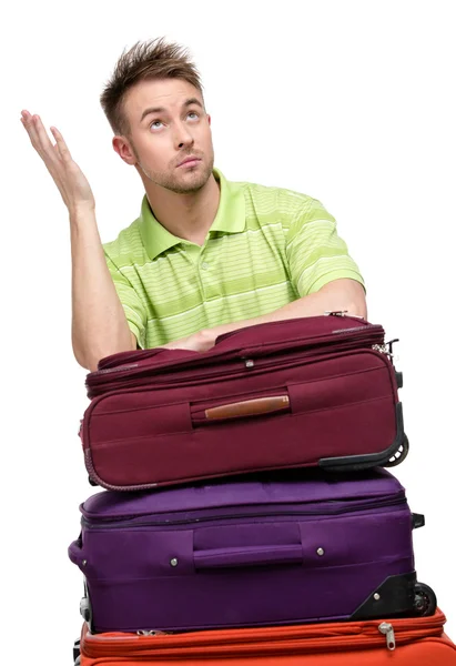 Man leaning on the pile of travel suitcases — Stock Photo, Image