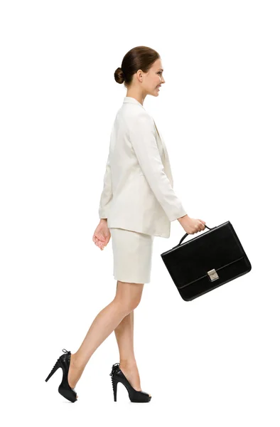 Profile of walking businesswoman with black case — Stock Photo, Image