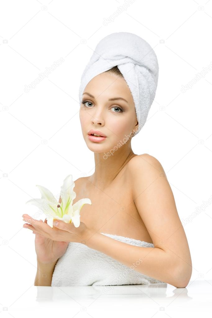 Girl with towel on head hands lily