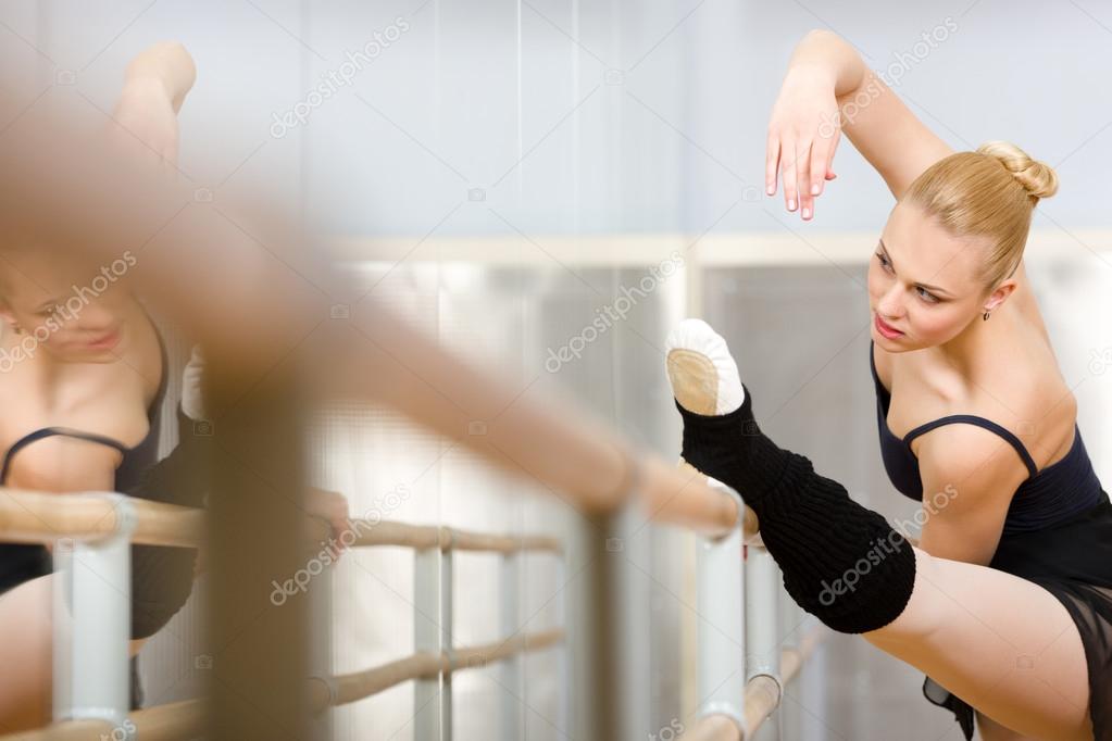 Pretty ballerina stretches herself near barre Stock Photo by ©agencyby  32077515