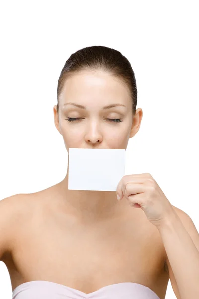 Nude girl hands copyspace card in front of her mouth — Stock Photo, Image