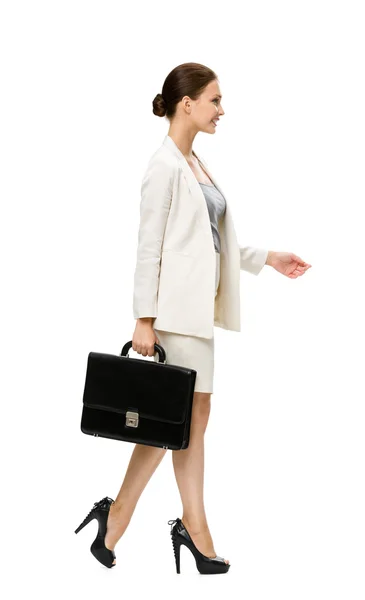 Profile of walking businesswoman with suitcase — Stock Photo, Image