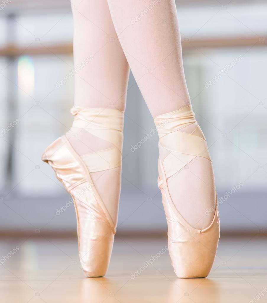 Close-up view of dancing legs of ballerina in pointes