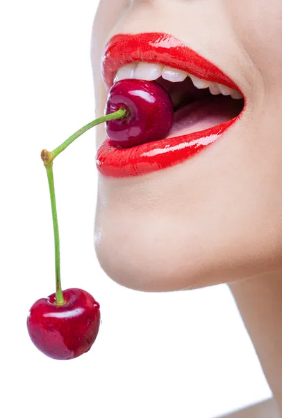 Close up of lady with red lips eating two berries Royalty Free Stock Photos
