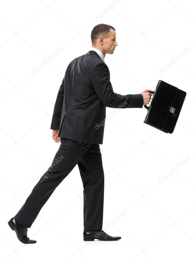 Walking with suitcase businessman