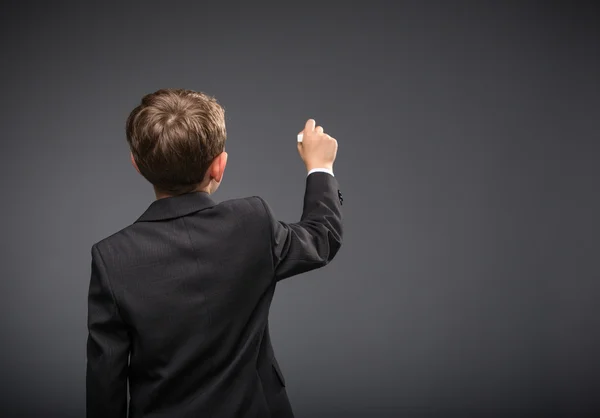 Backview of boy writing — Stock Photo, Image