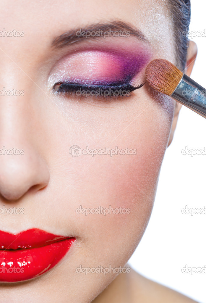 Half-face of girl applying makeup