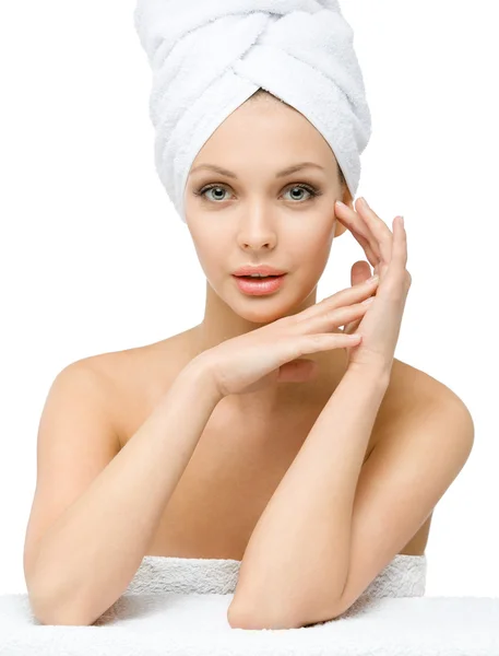 Girl with towel on head touches her face — Stock Photo, Image