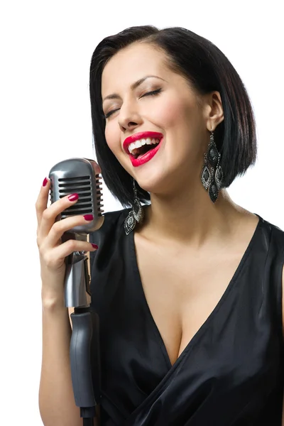 Female musician with closed eyes handing mic — Stock Photo, Image