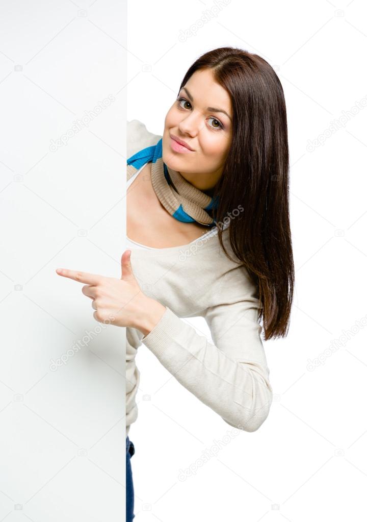 Girl pointing with forefinger at copyspace