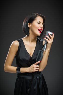 chanteuse avec les yeux fermés gardant mic