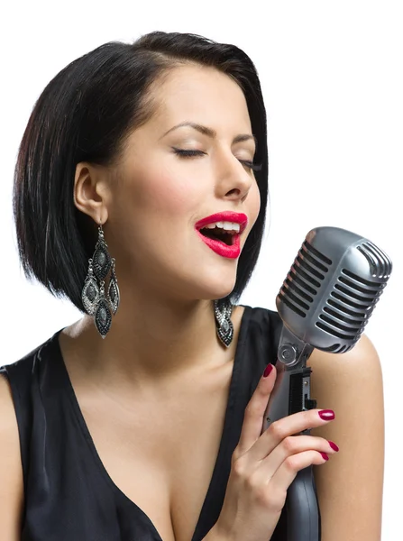 Female musician with closed eyes keeping mike — Stock Photo, Image