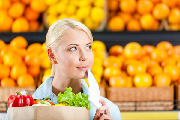 Girl hands package with fresh vegetables