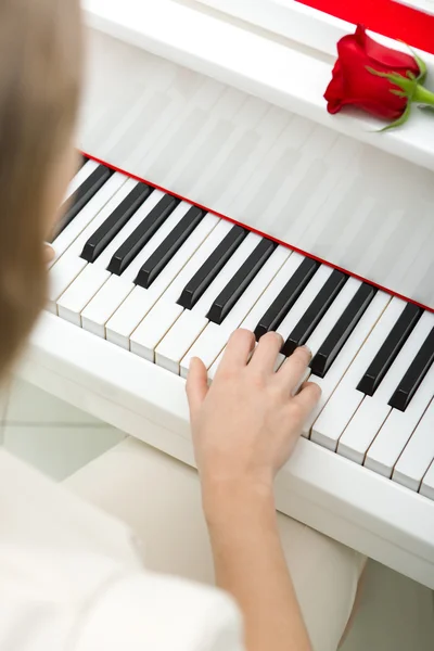 Close up of female hand playing piano — Stock Photo, Image