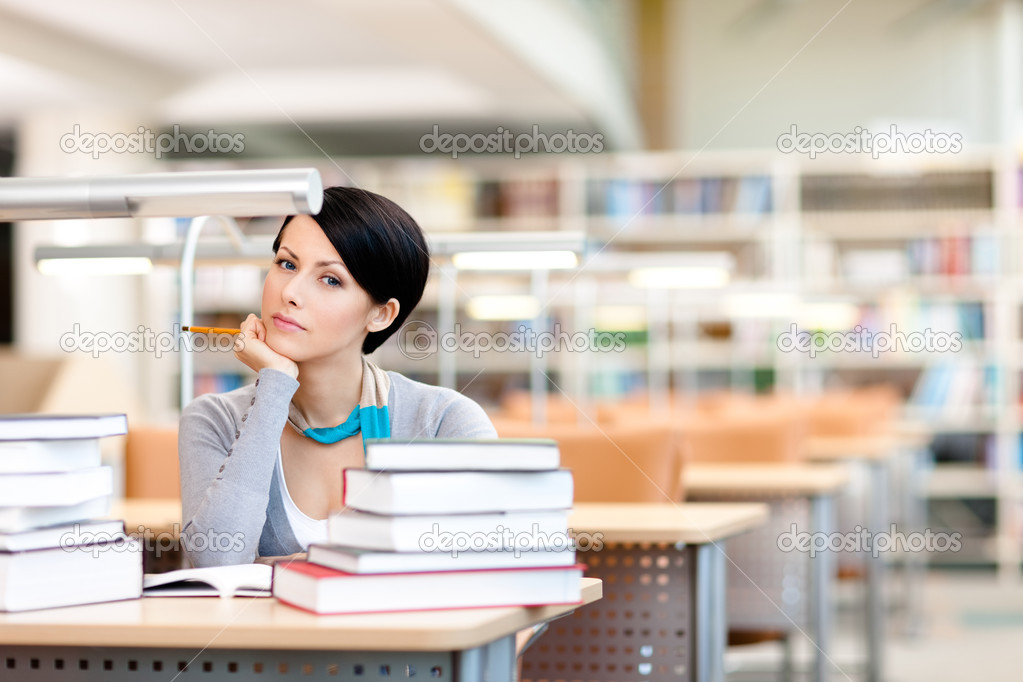 Pensive student studies at the reading hall