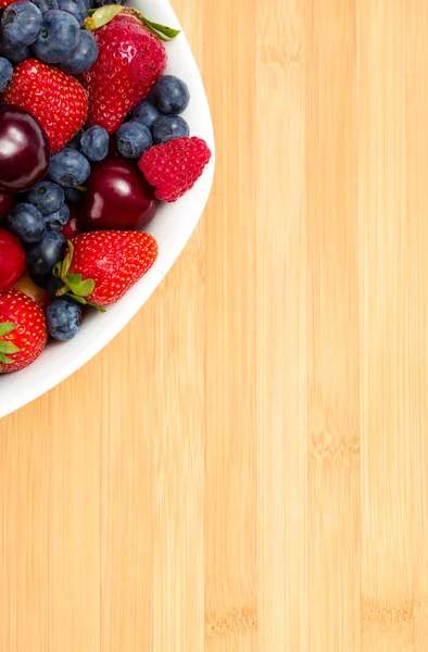 Close up of par of plate full of berries on table — Stock Photo, Image