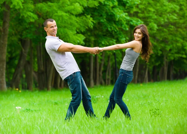 Full-length portrait of joining hands couple Stock Picture