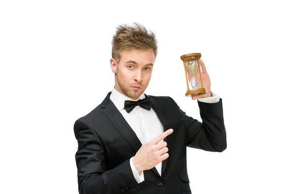 Businessman handing and pointing at sand glass — Stock Photo, Image