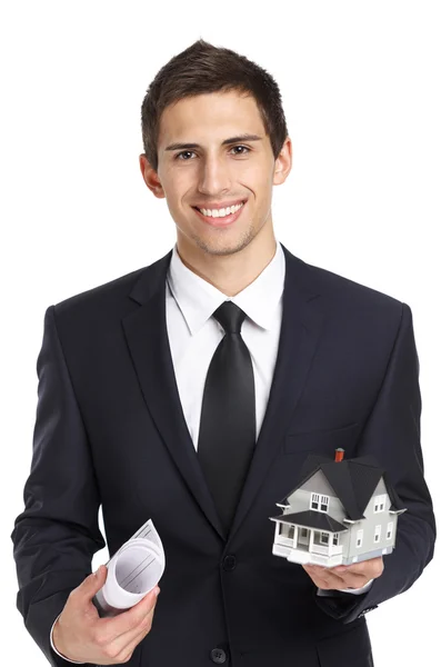Businessman with model house and blueprint — Stock Photo, Image