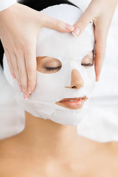 Hands of therapist apply mask to woman face — Stock Photo, Image