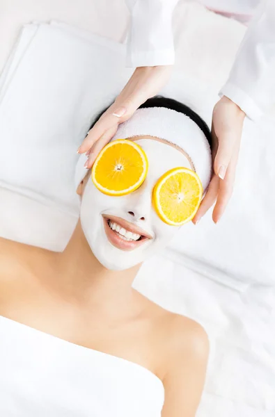 Girl with cream on face and orange cuts on eyes — Stock Photo, Image