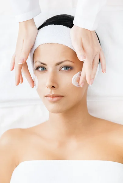 Hands of therapist apply cream to young woman face — Stock Photo, Image