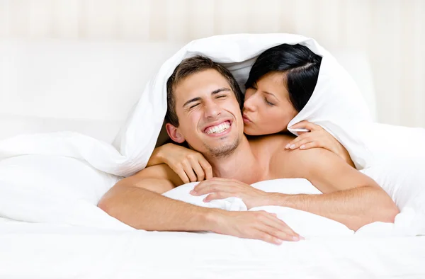 Close up of couple playing in bed — Stock Photo, Image