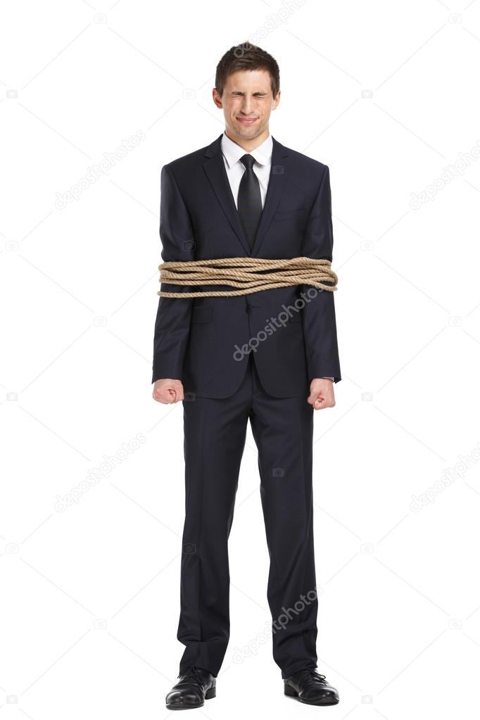 Full-length portrait of businessman tied with the rope