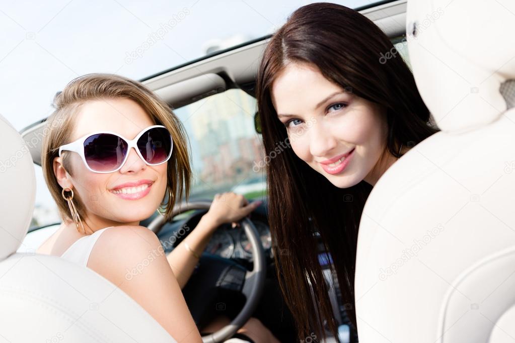 Two girls drive the car