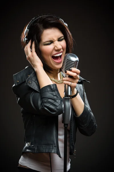 Rock musician with mic and earphones — Stock Photo, Image