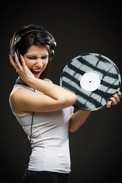 Pretty teenager with earphones and record in hands — Stock Photo, Image