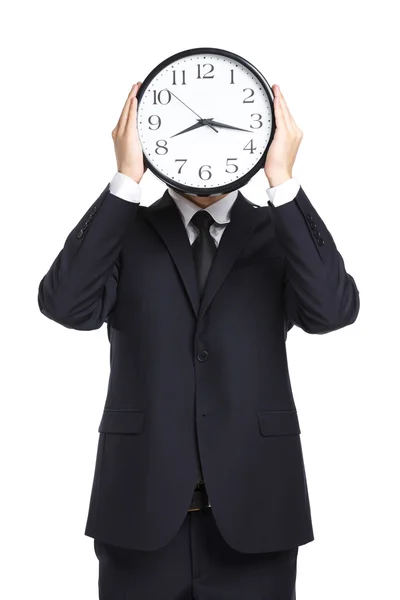 Бізнесмен тримає годинник перед обличчям — стокове фото