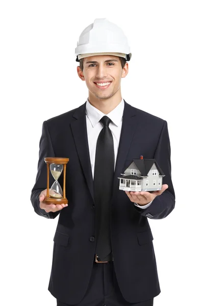 Real estate agent hands model house and hourglass — Stock Photo, Image