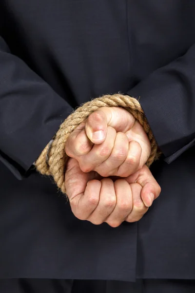 Close up of tied hands of businessman — Stock Photo, Image