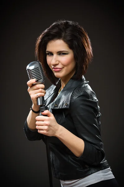 Female rock singer holding mike — Stock Photo, Image