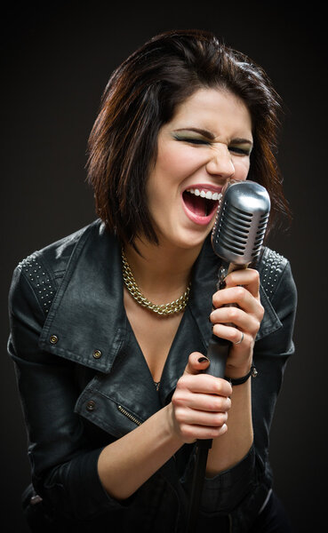 Female rock singer keeping microphone