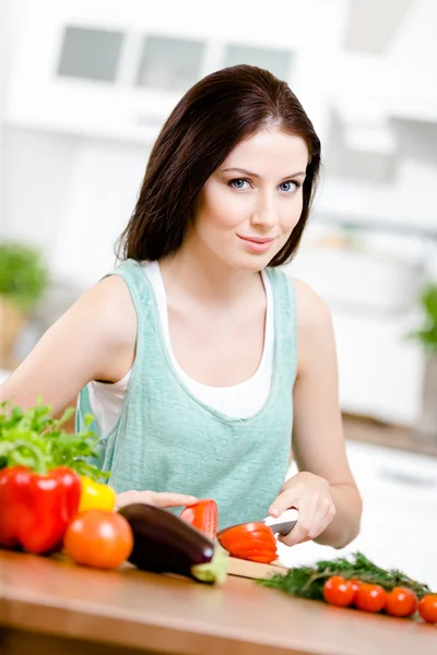 Girl slices groceries for salad Stock Picture