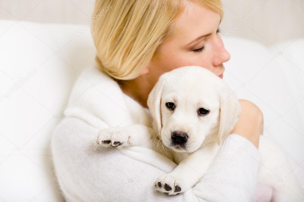 Woman embraces puppy