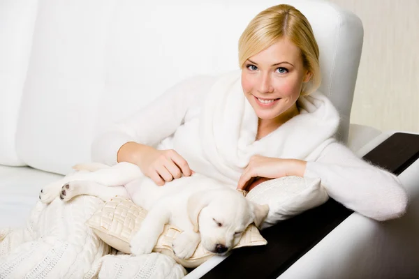 Woman with sleeping puppy — Stock Photo, Image