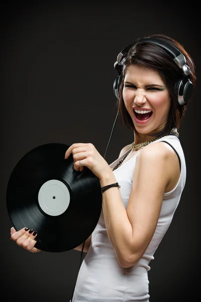 Teenager with earphones and record in hands — Stock Photo, Image