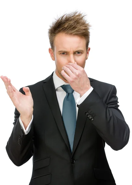 Businessman covering his nose — Stock Photo, Image