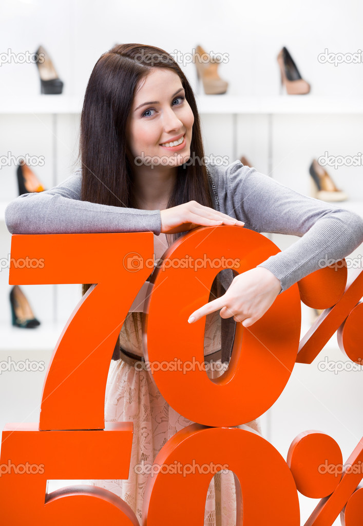 Woman showing the percentage of sales on shoes