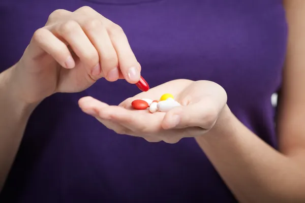 Girl takes antibiotics — Stock Photo, Image