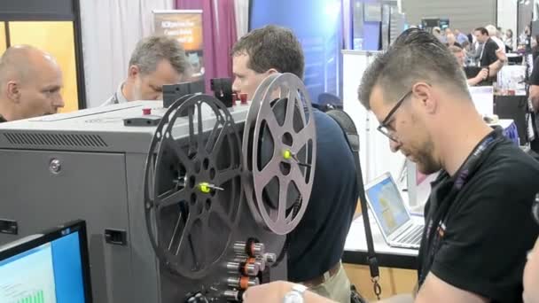 Operator demonstrates the film restoration during NAB Show 2014 in Las Vegas, USA. — Stock Video