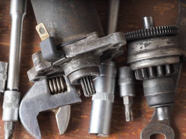 Scooter başlatıcısı masadaki parçaları ve araçları tamir eder