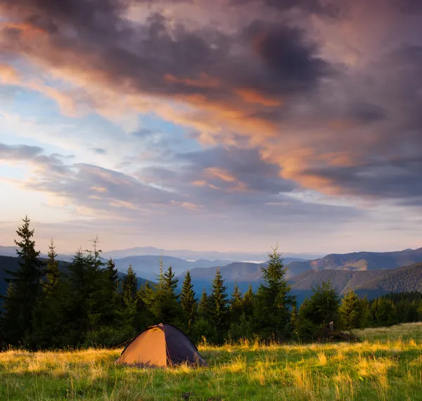 Sunrise in the mountains with a tent — Stock Photo, Image